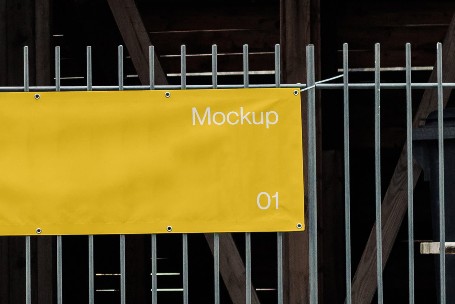 Yellow banner mockup hanging on metal rods with a construction background, ideal for branding presentation and design display.